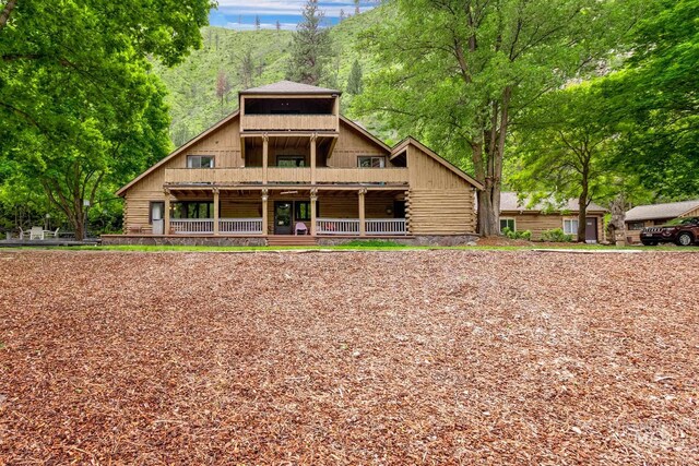 rear view of house featuring a porch