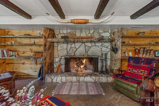 living room featuring a stone fireplace