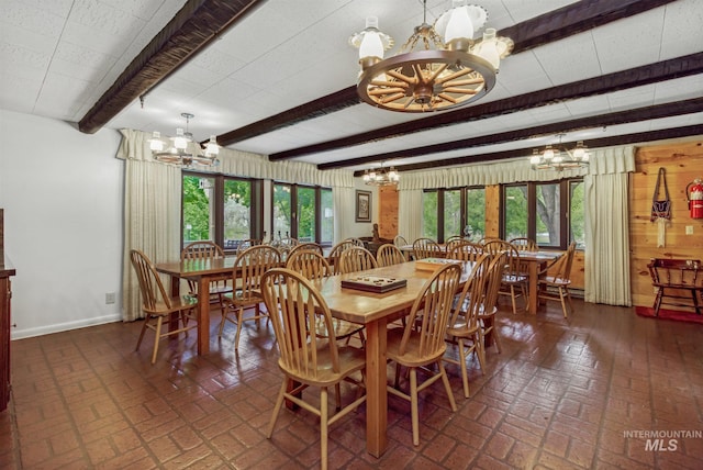 dining area featuring beam ceiling and a chandelier