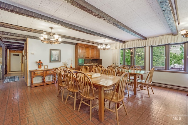 dining space with a notable chandelier, a baseboard radiator, and beamed ceiling