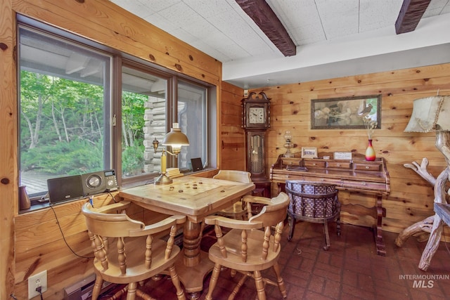 dining area featuring wooden walls