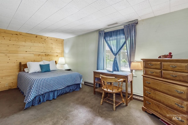 bedroom featuring wooden walls and dark carpet