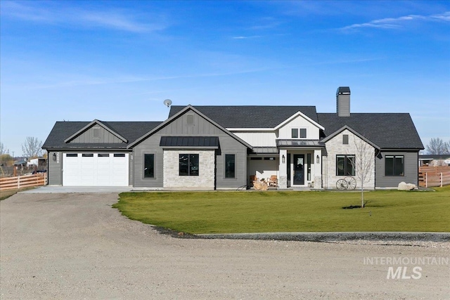 modern farmhouse featuring a standing seam roof, a front yard, driveway, and fence