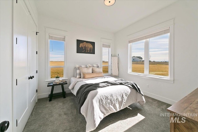 carpeted bedroom featuring baseboards