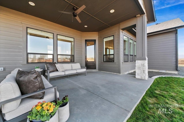 view of patio with an outdoor living space and ceiling fan