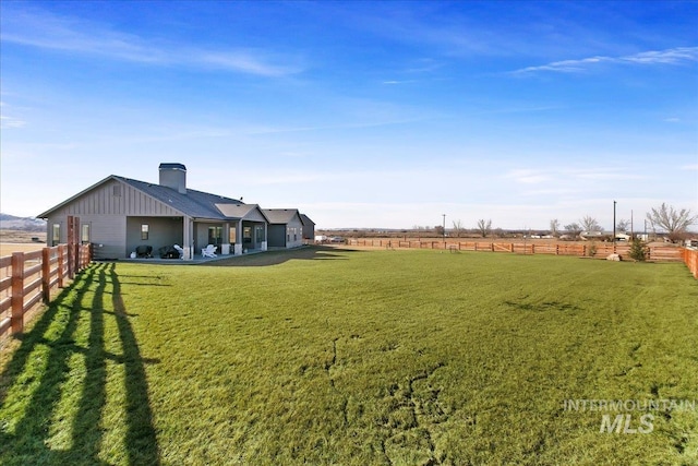 view of yard featuring a rural view and fence