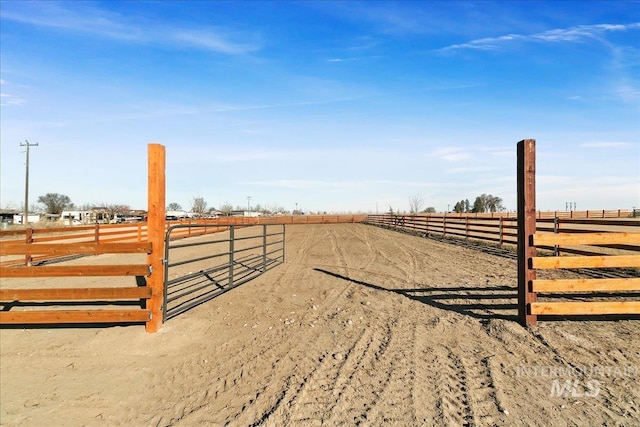 view of yard with an enclosed area and a rural view