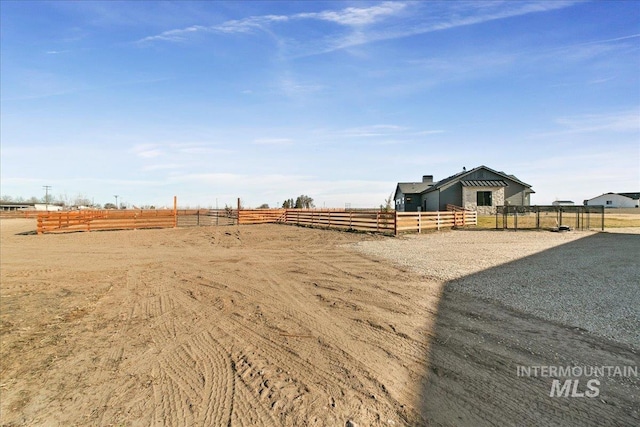 view of yard featuring fence and a rural view