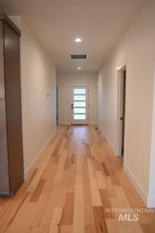 hall with light hardwood / wood-style floors