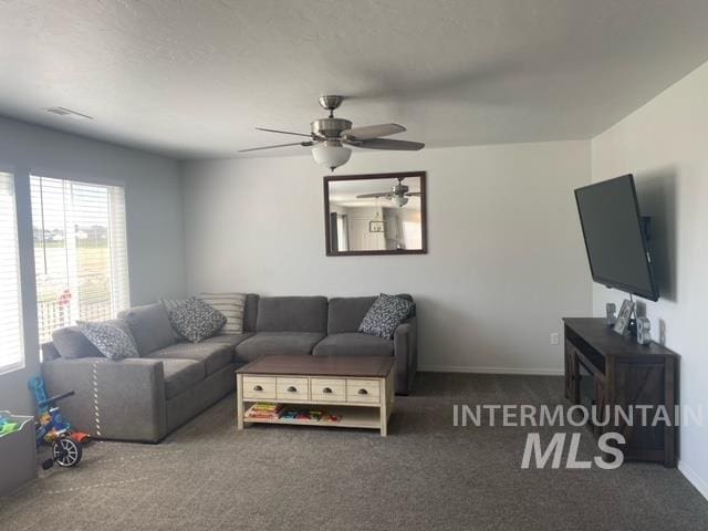 carpeted living room featuring ceiling fan