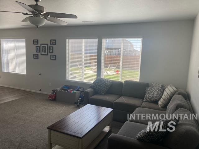 living room featuring ceiling fan and carpet flooring