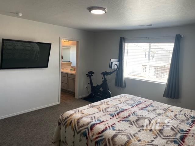 carpeted bedroom with connected bathroom