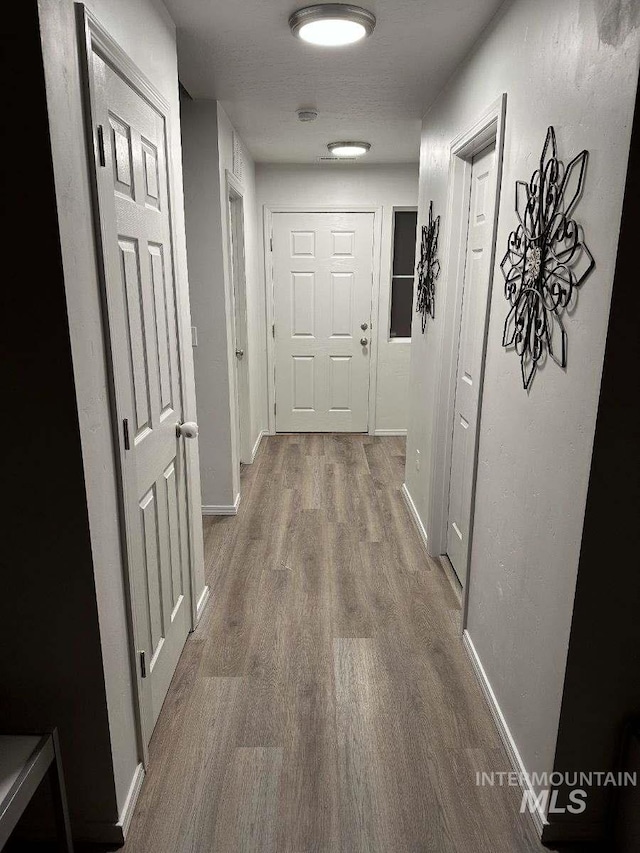 hallway featuring hardwood / wood-style flooring