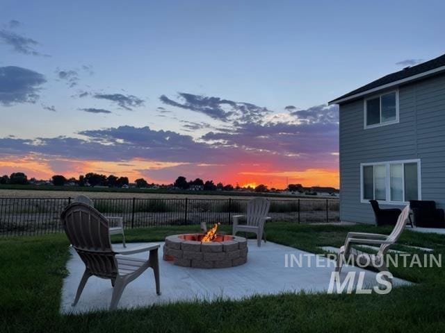 yard at dusk with a patio and a fire pit