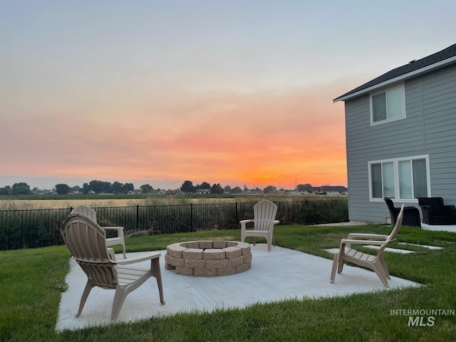 patio terrace at dusk with a yard and a fire pit