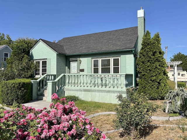 710 Locust St, Twin Falls, ID 83301 - view of front of property with a chimney, roof with shingles, and brick siding