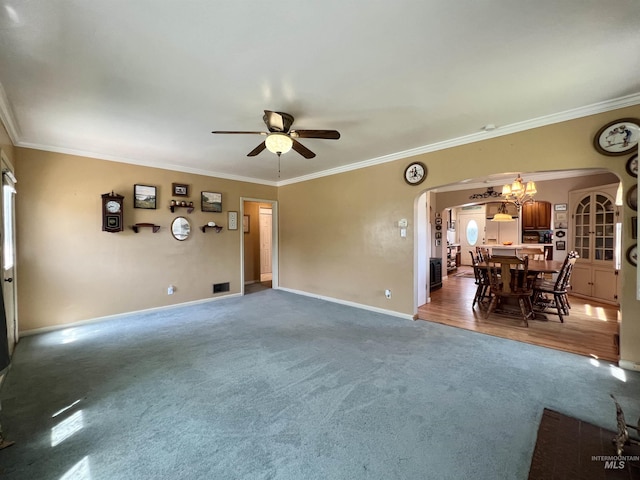 710 Locust St, Twin Falls, ID 83301 - unfurnished living room with arched walkways, carpet, ornamental molding, a ceiling fan, and a chandelier