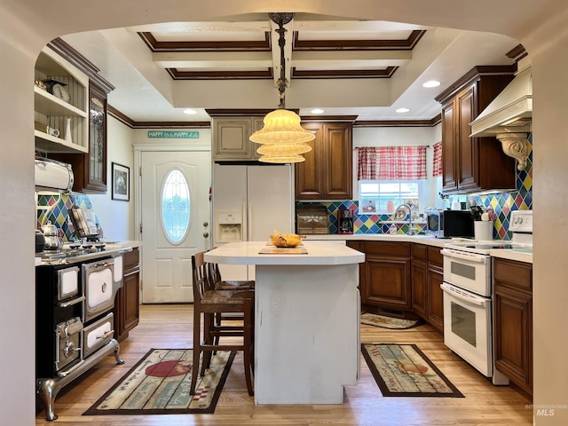 710 Locust St, Twin Falls, ID 83301 - kitchen featuring white appliances, ornamental molding, premium range hood, light countertops, and backsplash