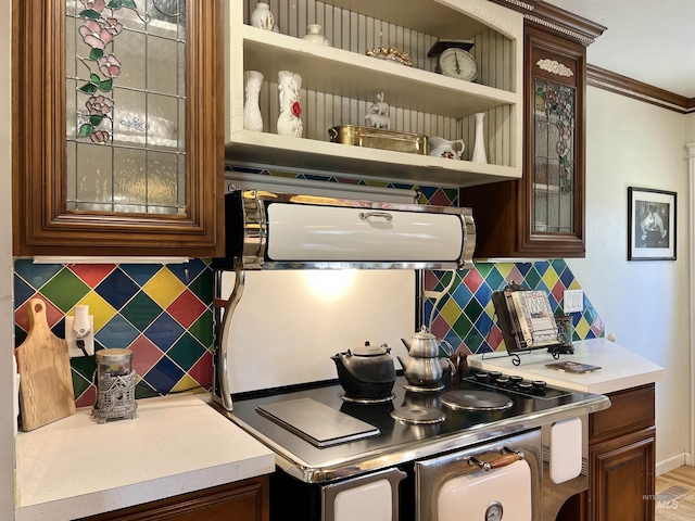 710 Locust St, Twin Falls, ID 83301 - kitchen with tasteful backsplash, glass insert cabinets, light countertops, and ornamental molding