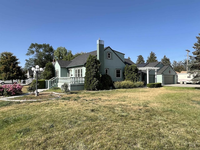 710 Locust St, Twin Falls, ID 83301 - view of side of property featuring a garage, a yard, a chimney, driveway, and roof with shingles