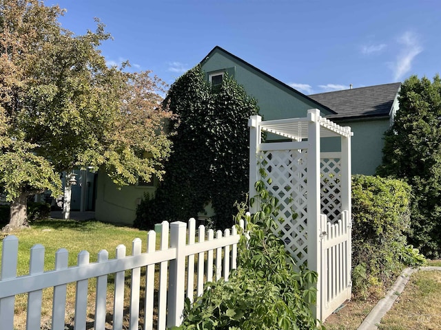 710 Locust St, Twin Falls, ID 83301 - view of side of property with stucco siding and roof with shingles