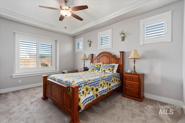 bedroom with a tray ceiling, ornamental molding, light colored carpet, and ceiling fan