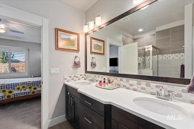 bathroom with vanity, an enclosed shower, tasteful backsplash, and ceiling fan