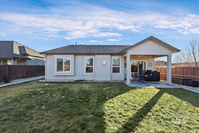 rear view of house with a yard and a patio area