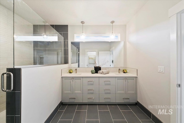 bathroom with tile patterned flooring, vanity, and walk in shower