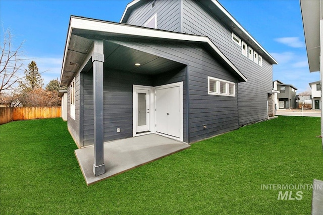 rear view of house featuring a yard