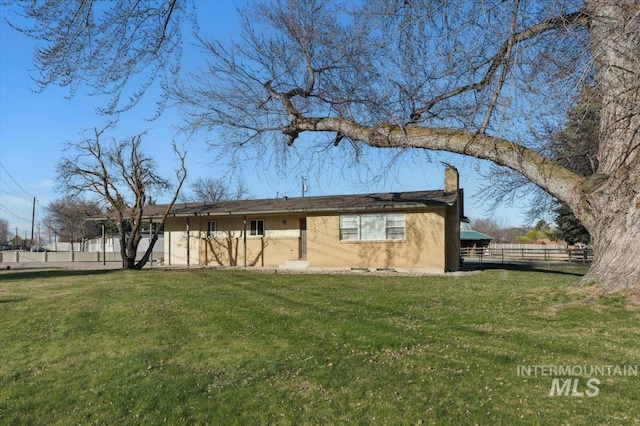 4320 N Locust Grv, Meridian, ID 83642 - view of side of property with fence, a chimney, and a lawn