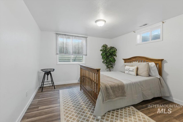 4320 N Locust Grv, Meridian, ID 83642 - bedroom featuring baseboards, wood finished floors, and visible vents