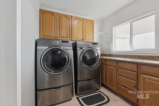 4320 N Locust Grv, Meridian, ID 83642 - clothes washing area with washer and dryer, light tile patterned floors, and cabinet space