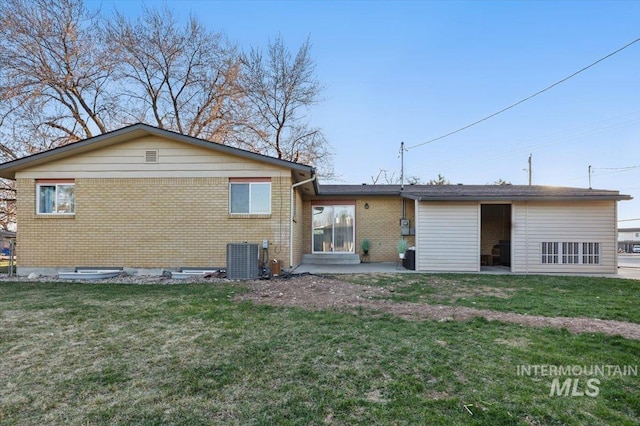 4320 N Locust Grv, Meridian, ID 83642 - rear view of property featuring central air condition unit, a yard, and brick siding