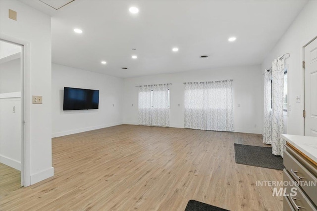 4320 N Locust Grv, Meridian, ID 83642 - unfurnished living room with recessed lighting, baseboards, and light wood finished floors