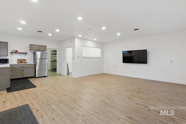 4320 N Locust Grv, Meridian, ID 83642 - unfurnished living room featuring recessed lighting, baseboards, and light wood finished floors