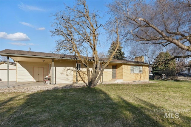 4320 N Locust Grv, Meridian, ID 83642 - back of property with a lawn, a chimney, and an attached carport