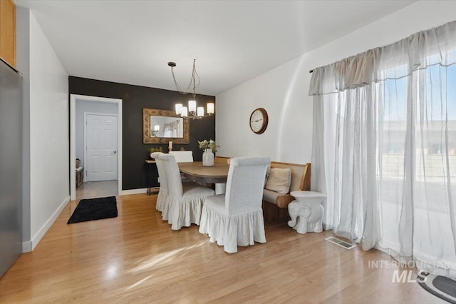 4320 N Locust Grv, Meridian, ID 83642 - dining area featuring visible vents, light wood finished floors, and an inviting chandelier