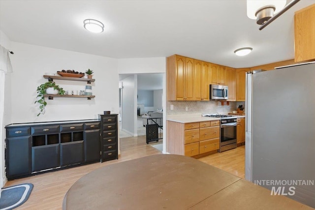 4320 N Locust Grv, Meridian, ID 83642 - kitchen with decorative backsplash, open shelves, light countertops, stainless steel appliances, and light wood-style flooring