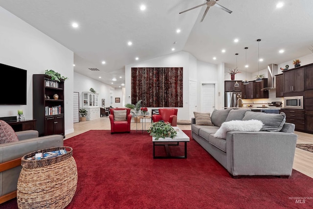 living room with dark wood-type flooring, high vaulted ceiling, and ceiling fan