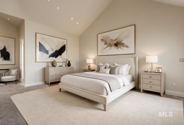 carpeted bedroom featuring high vaulted ceiling