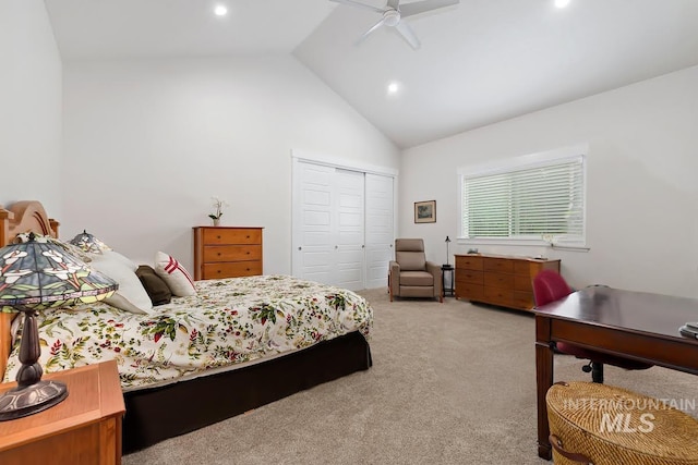 carpeted bedroom with ceiling fan, high vaulted ceiling, and a closet