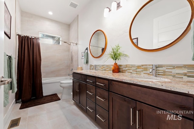 full bathroom featuring toilet, vanity, shower / bath combo, tile patterned flooring, and backsplash