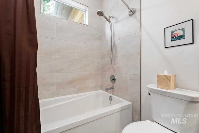 bathroom with shower / tub combo with curtain and toilet