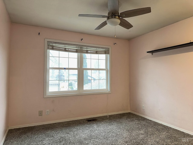 carpeted spare room featuring ceiling fan