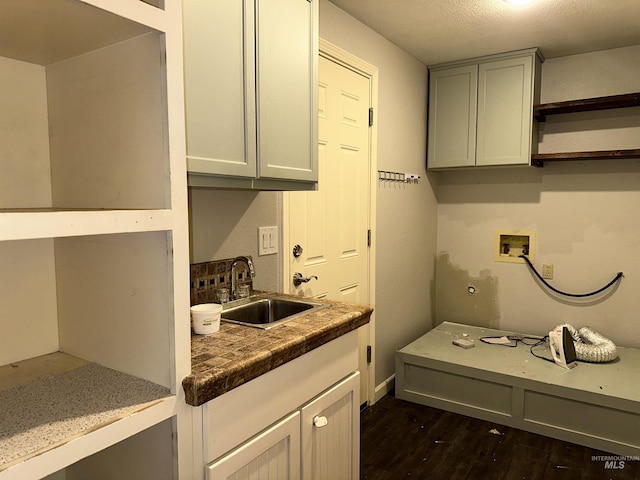 kitchen with a textured ceiling, dark hardwood / wood-style floors, gray cabinets, and sink