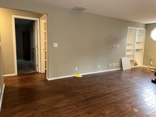 unfurnished room with dark hardwood / wood-style flooring