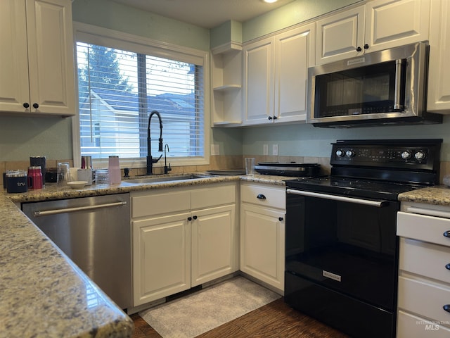 kitchen with white cabinets, hardwood / wood-style flooring, sink, and appliances with stainless steel finishes