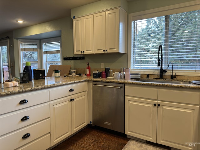 kitchen featuring stainless steel dishwasher, white cabinets, sink, and dark wood-type flooring