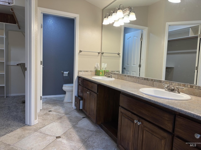 bathroom featuring tile patterned floors, vanity, and toilet